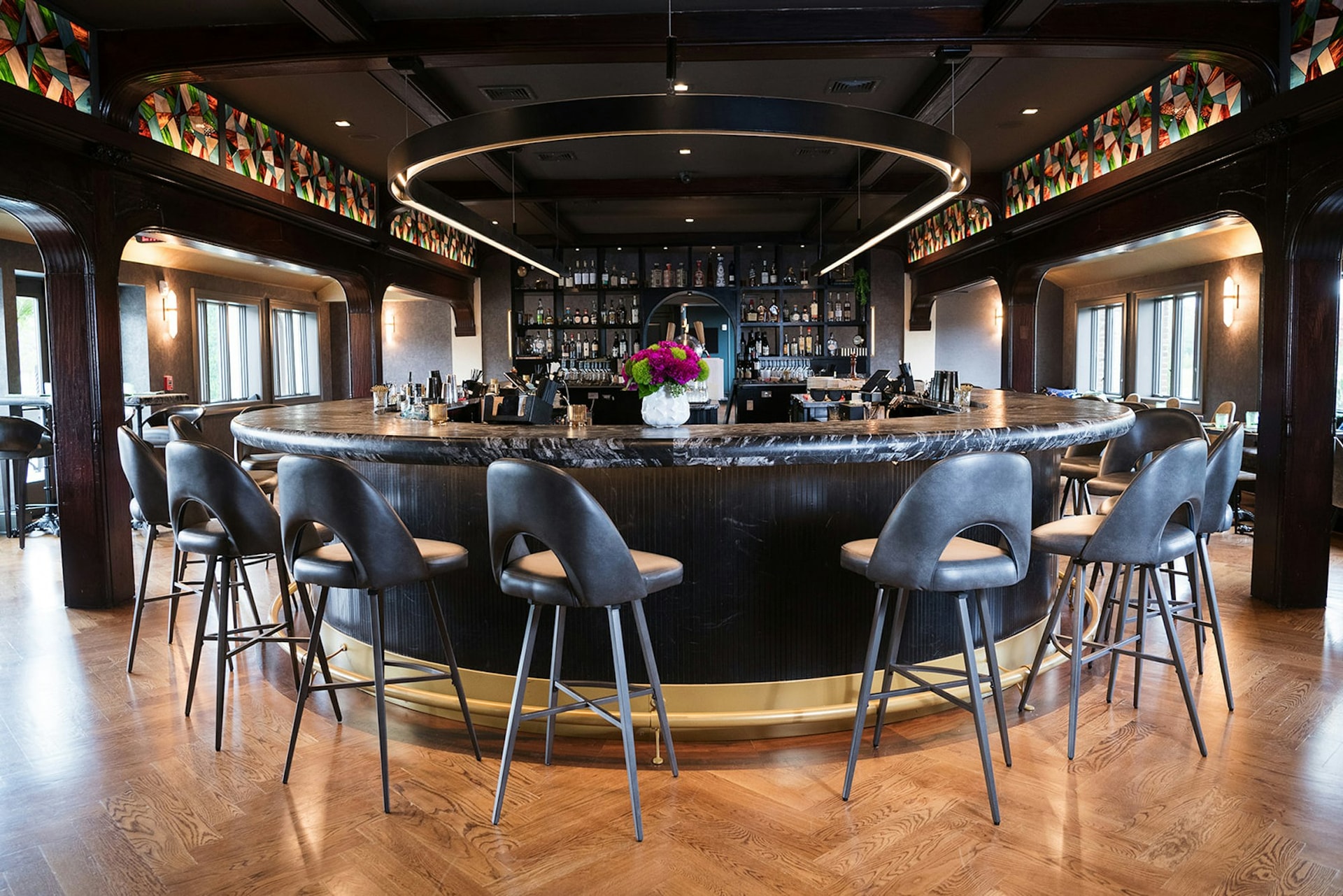 The circular bar with blue leather stools and ring chandelier at TillingHouse