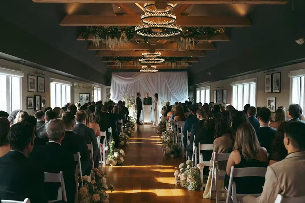A candlelit wedding ceremony beneath the timber beams of the Byron Nelson Room at TillingHouse