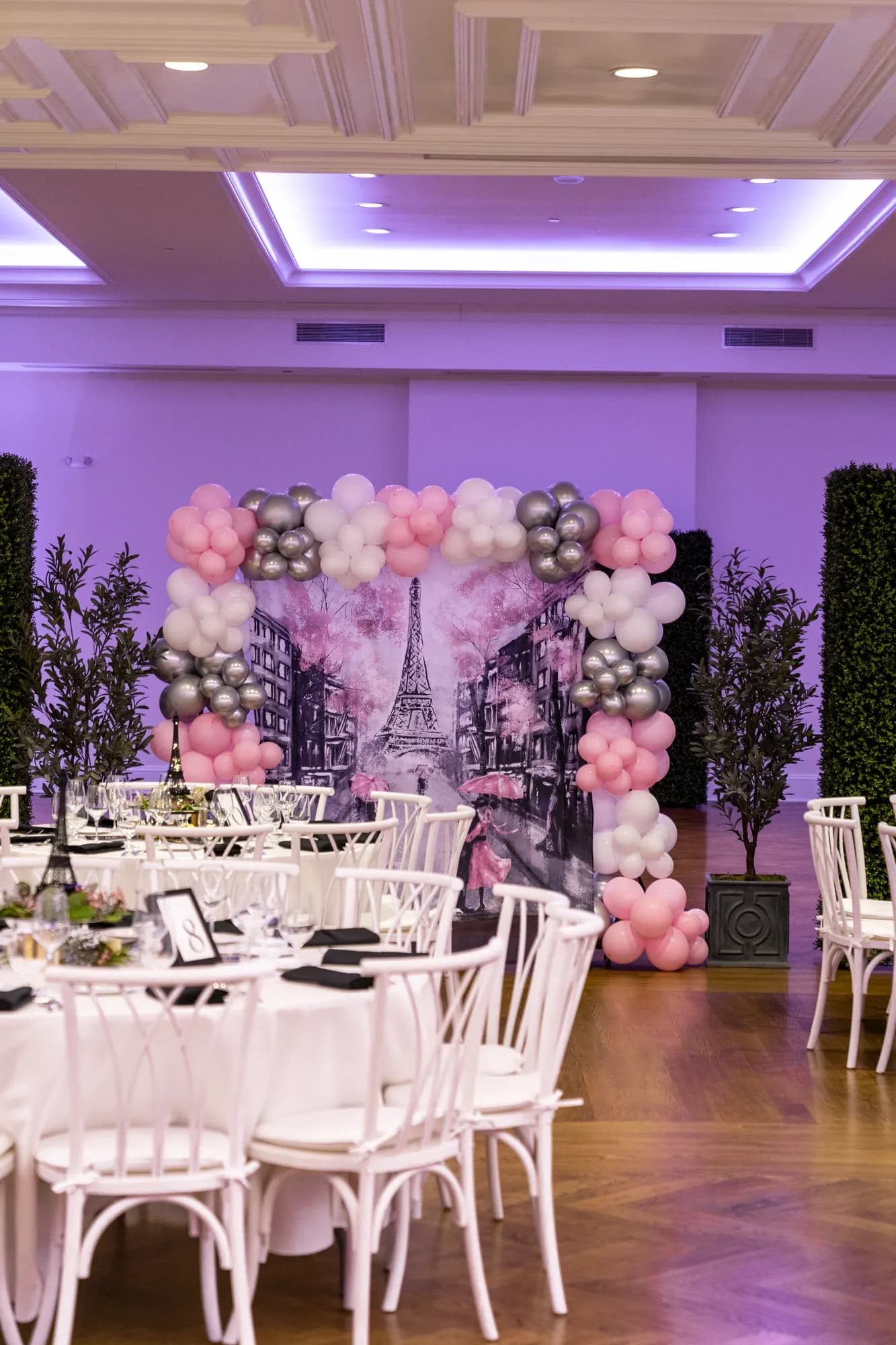 A floral arch and set tables for a shower celebration in the TillingHouse ballroom