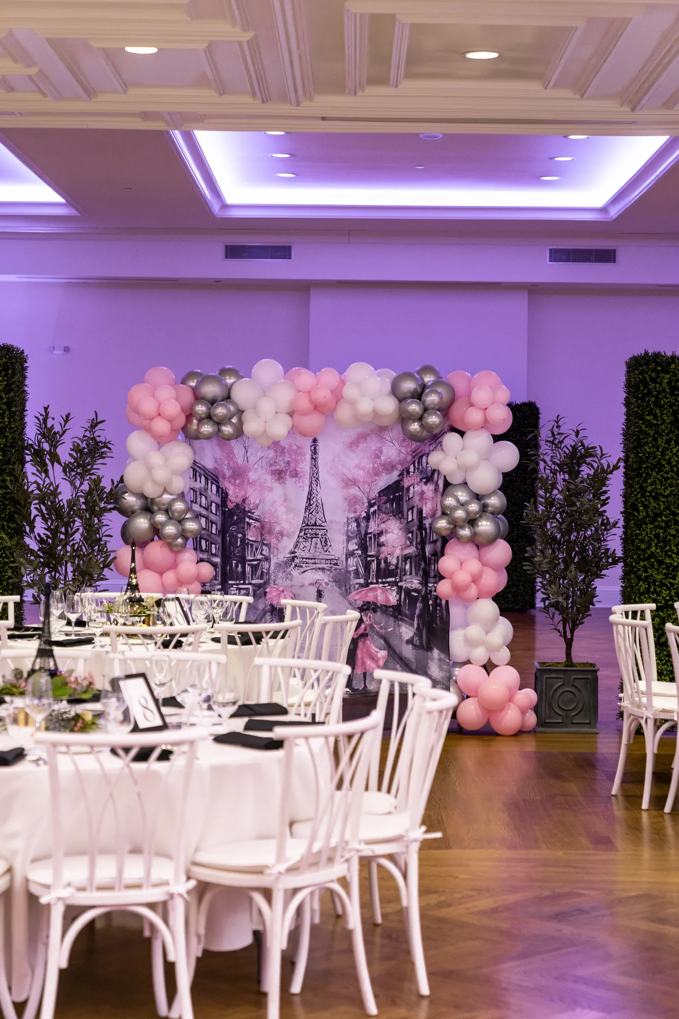 A floral arch and set tables for a shower celebration in the TillingHouse ballroom