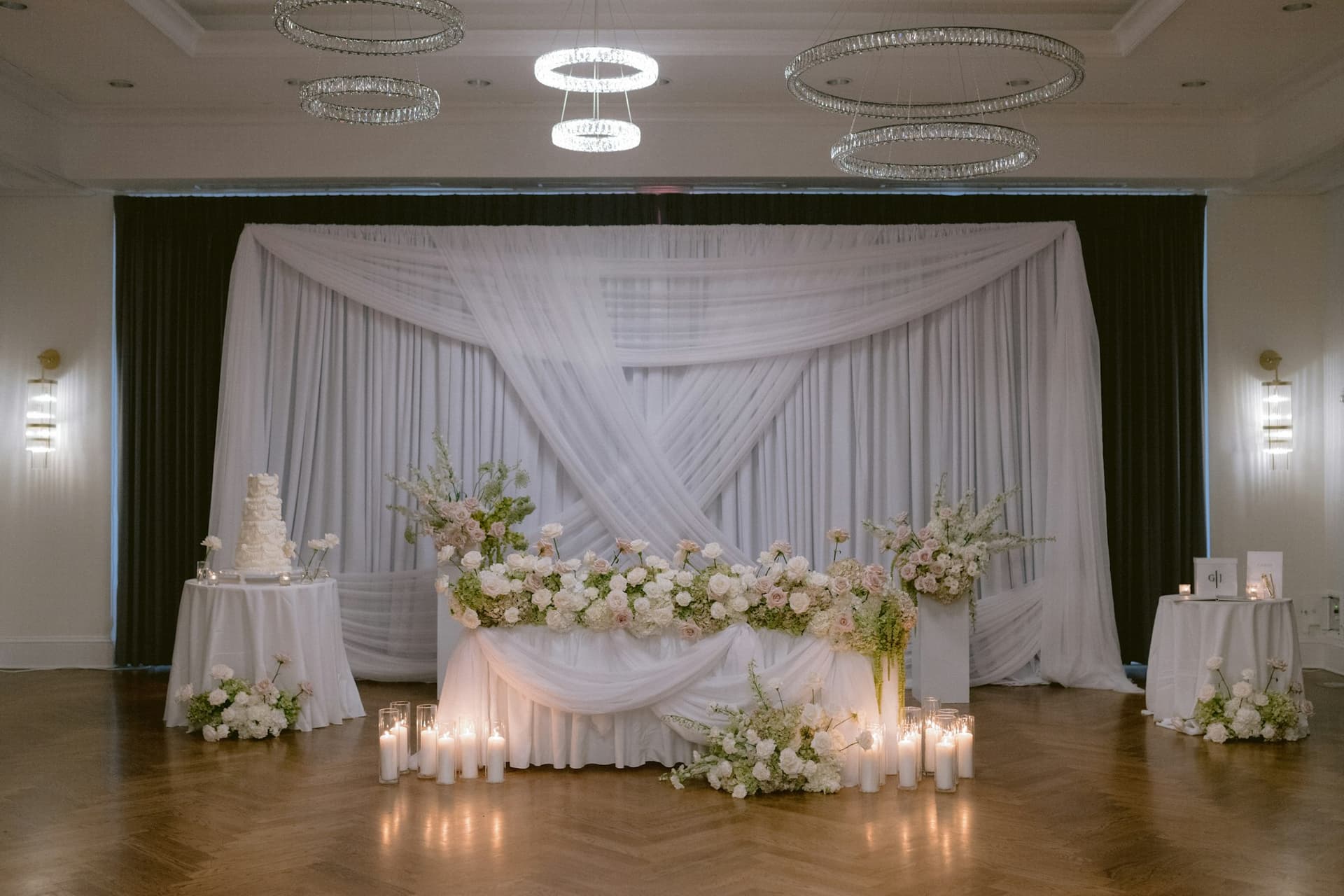 A sweetheart ceremony backdrop of white draping and florals at TillingHouse