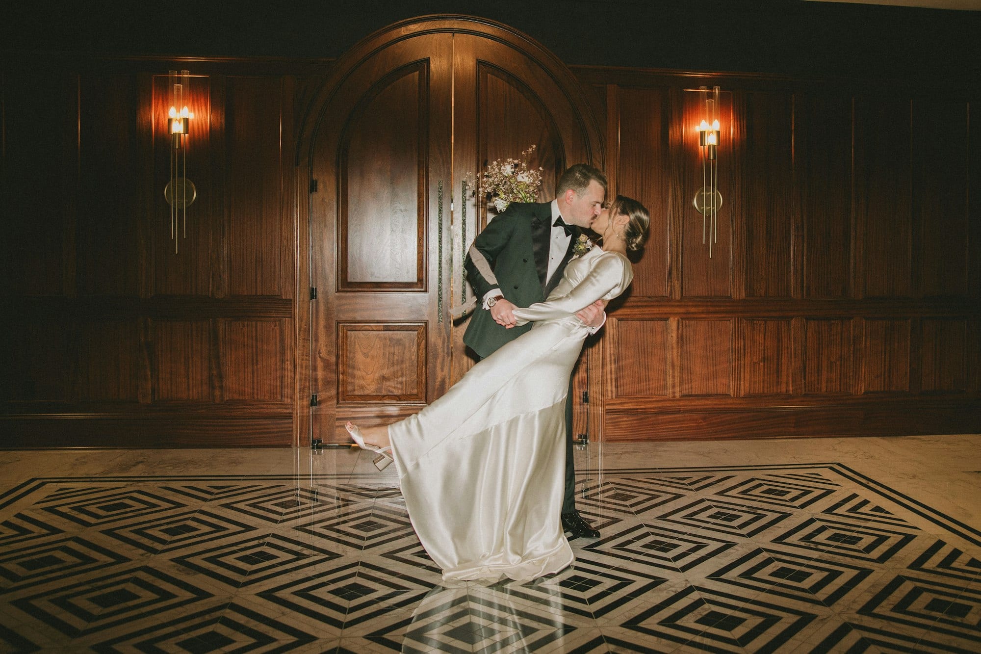 A bride and groom sharing a first dance on the patterned floor at TillingHouse