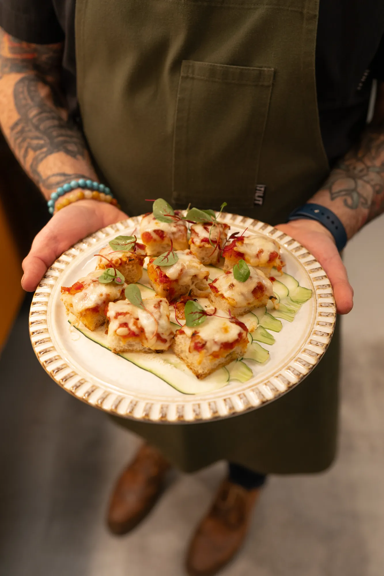 A chef presenting a plated appetizer at TillingHouse in Eatontown, NJ