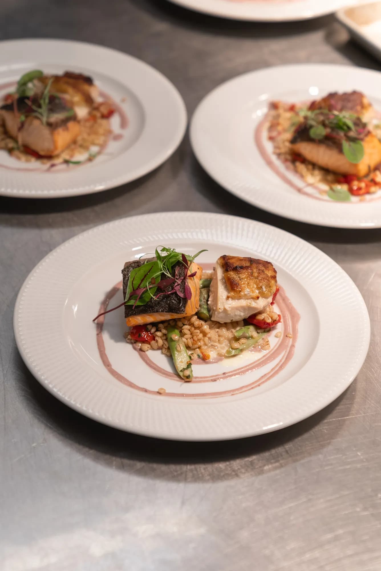 Plated entrees presented on white china at a TillingHouse event in Monmouth County, NJ