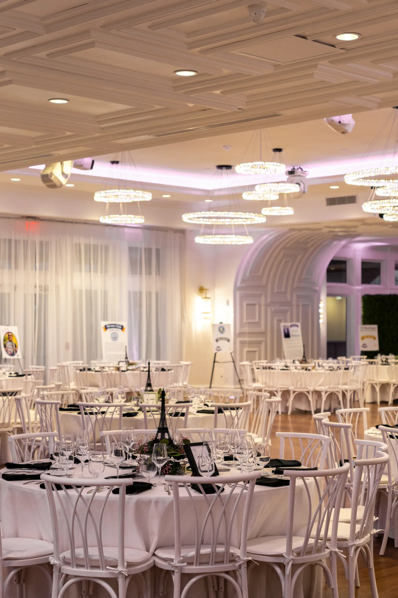 The TillingHouse ballroom set with round tables and chandeliers for a reception