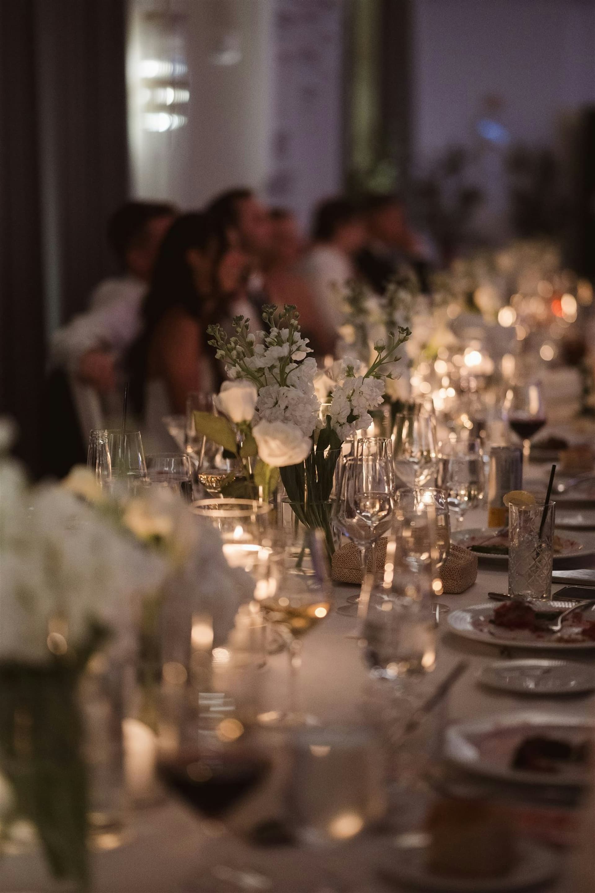 A long candlelit reception table set with tall candelabra at TillingHouse