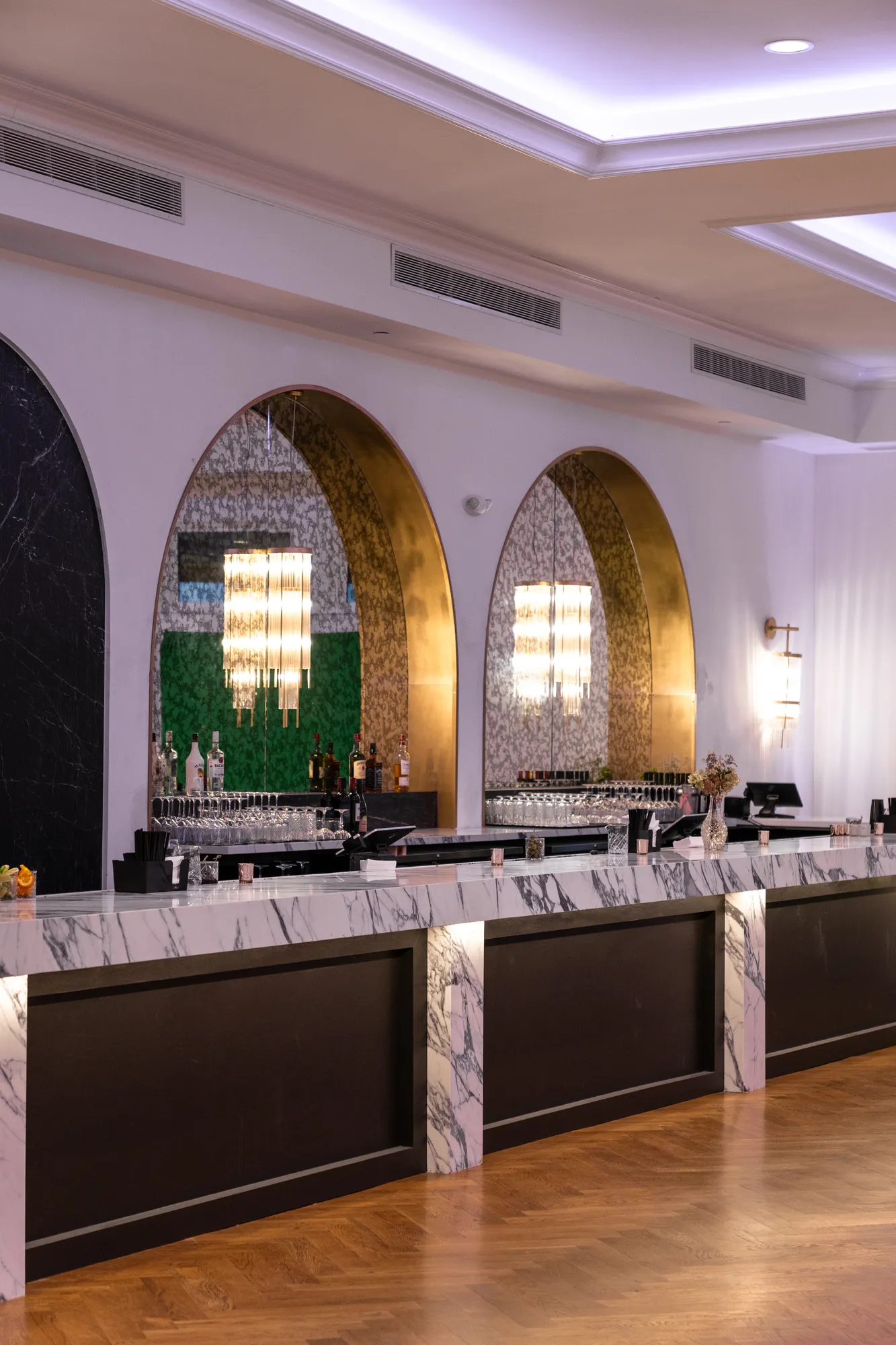 The grand ballroom and marble bar beneath arched windows at TillingHouse in Eatontown, NJ